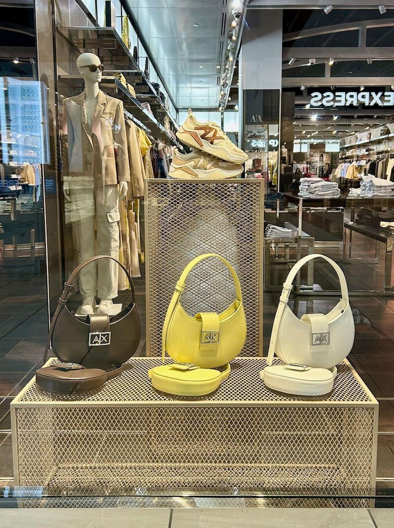 Window riser with yellow and white handbags
