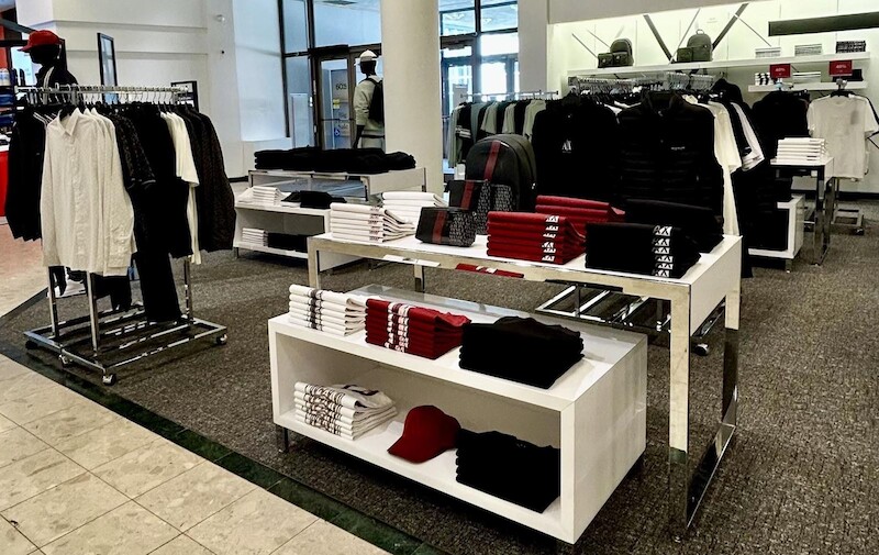 Concession tables with folded tees and caps